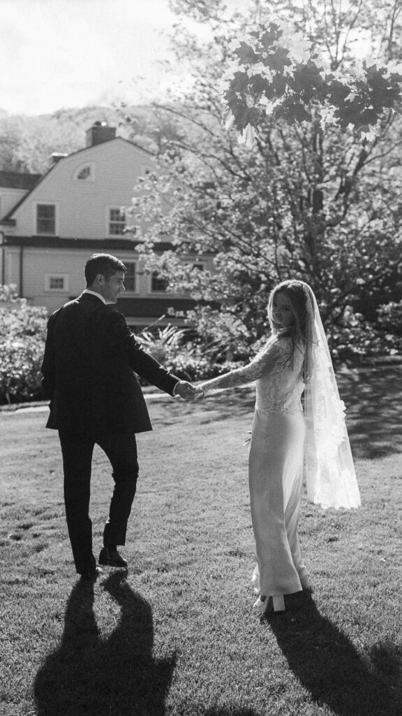 couple walking toward Bedford Post Inn, small intimate wedding venues